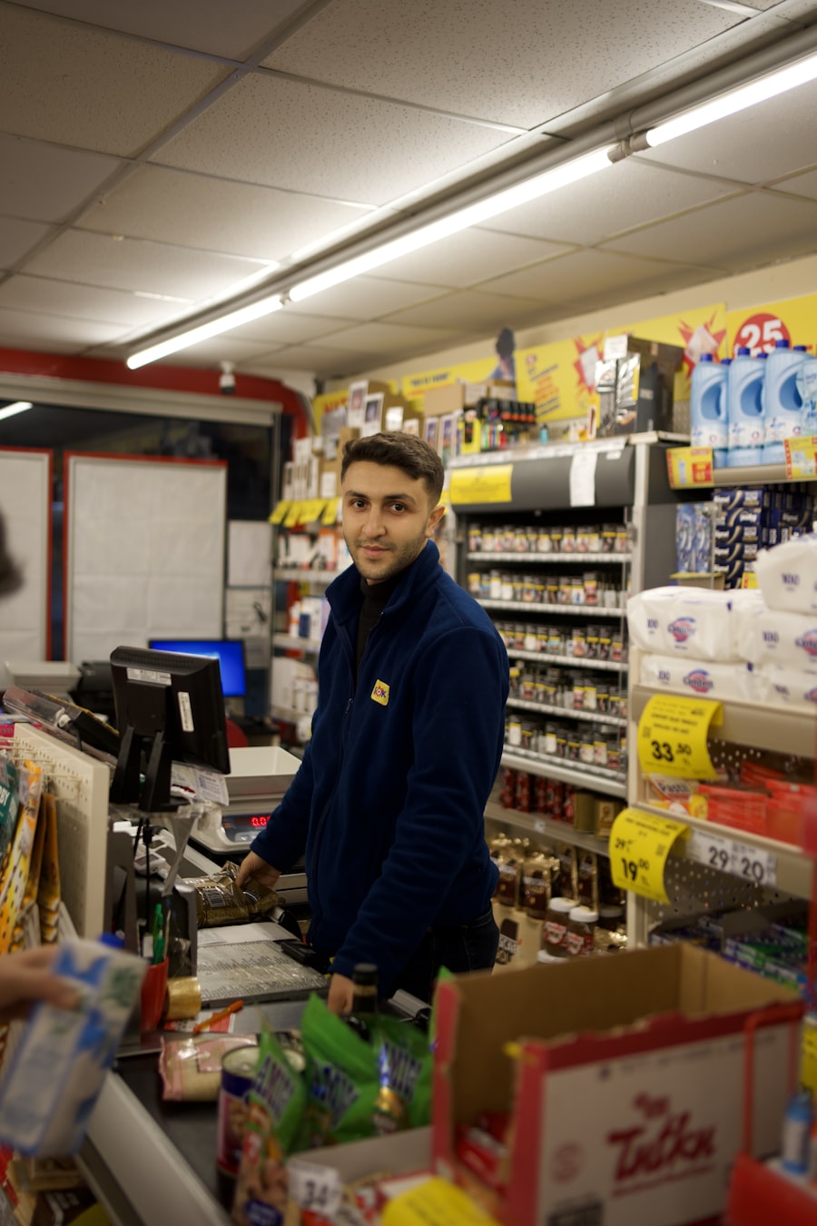 Shop assistant serving a customer at a retail till
