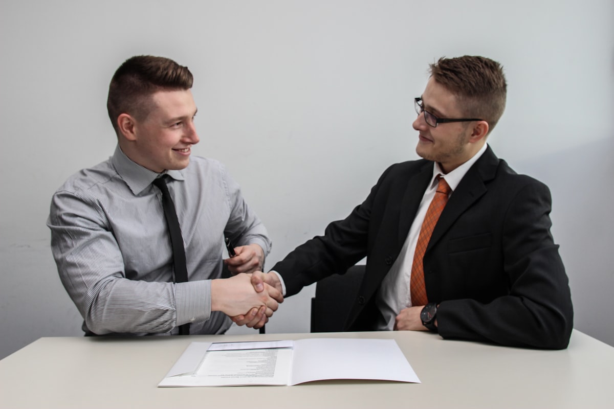 Two business people shaking hands after agreeing a new payment setup