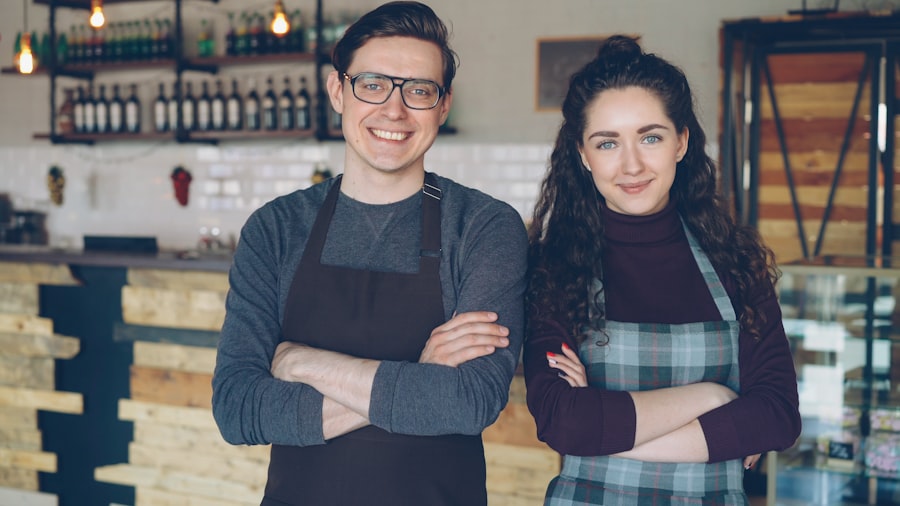 Two café owners standing behind their counter